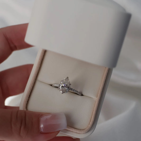 2 carat pear moissanite ring in silver with hidden halo and pavé band in proposal box