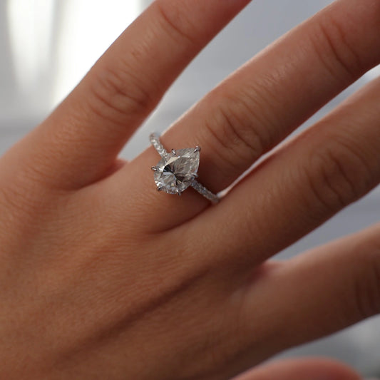 2 carat pear moissanite ring in silver with pavé band