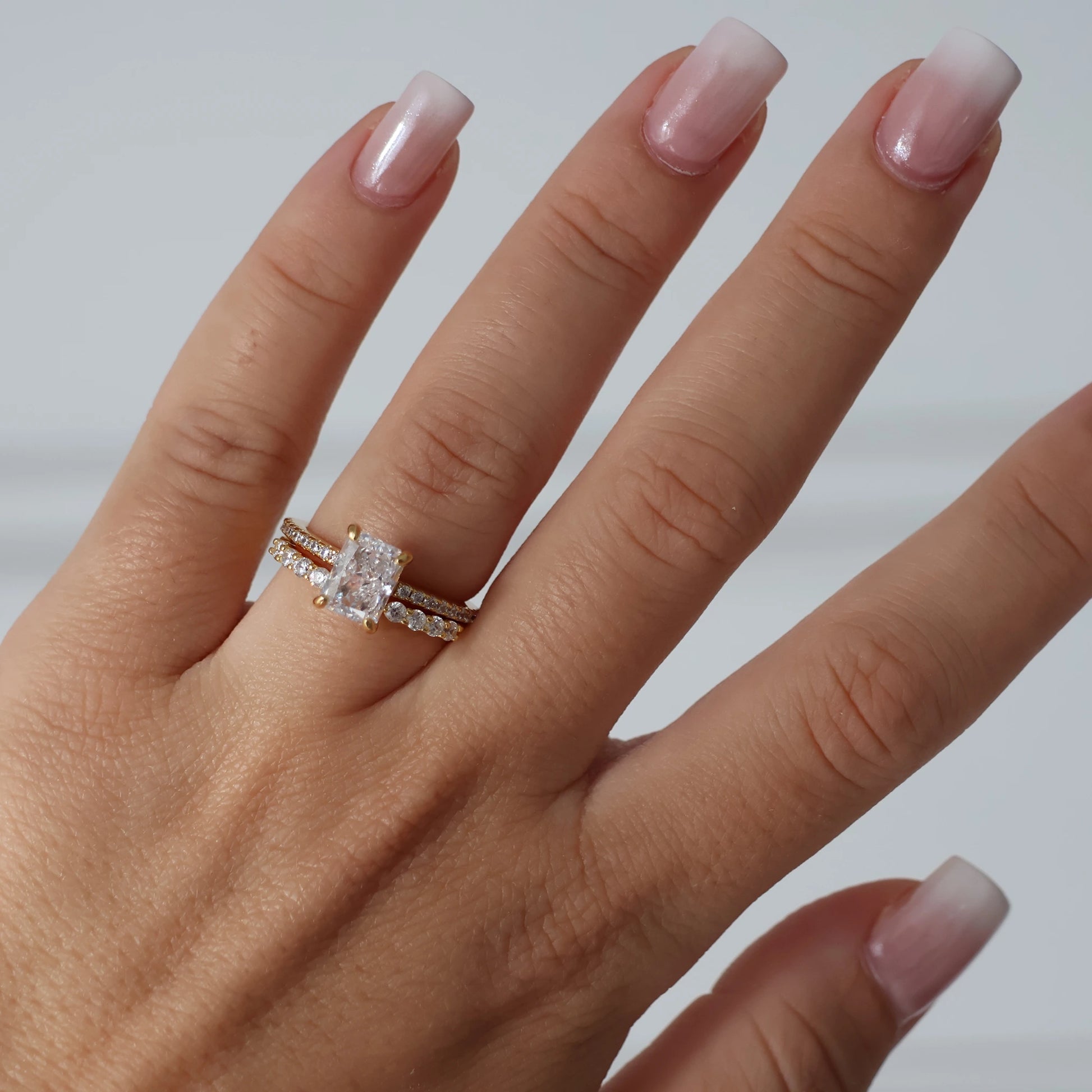 2 carat radiant cut cubic zirconia ring in gold with pavé band and hidden halo