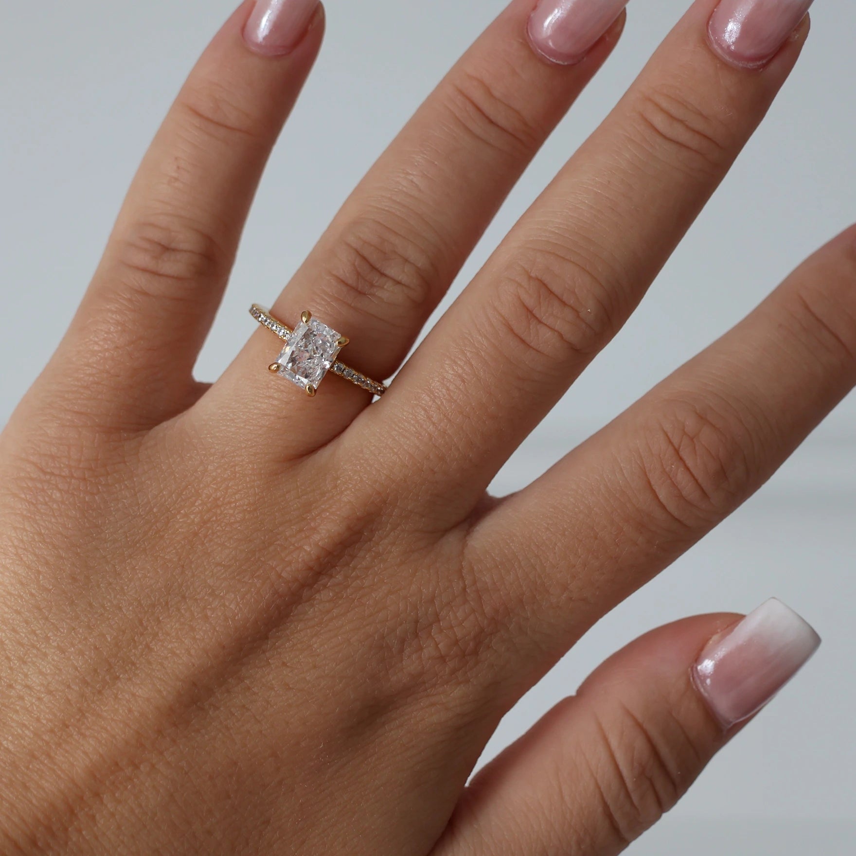 2 carat radiant cut cubic zirconia ring in gold with pavé band