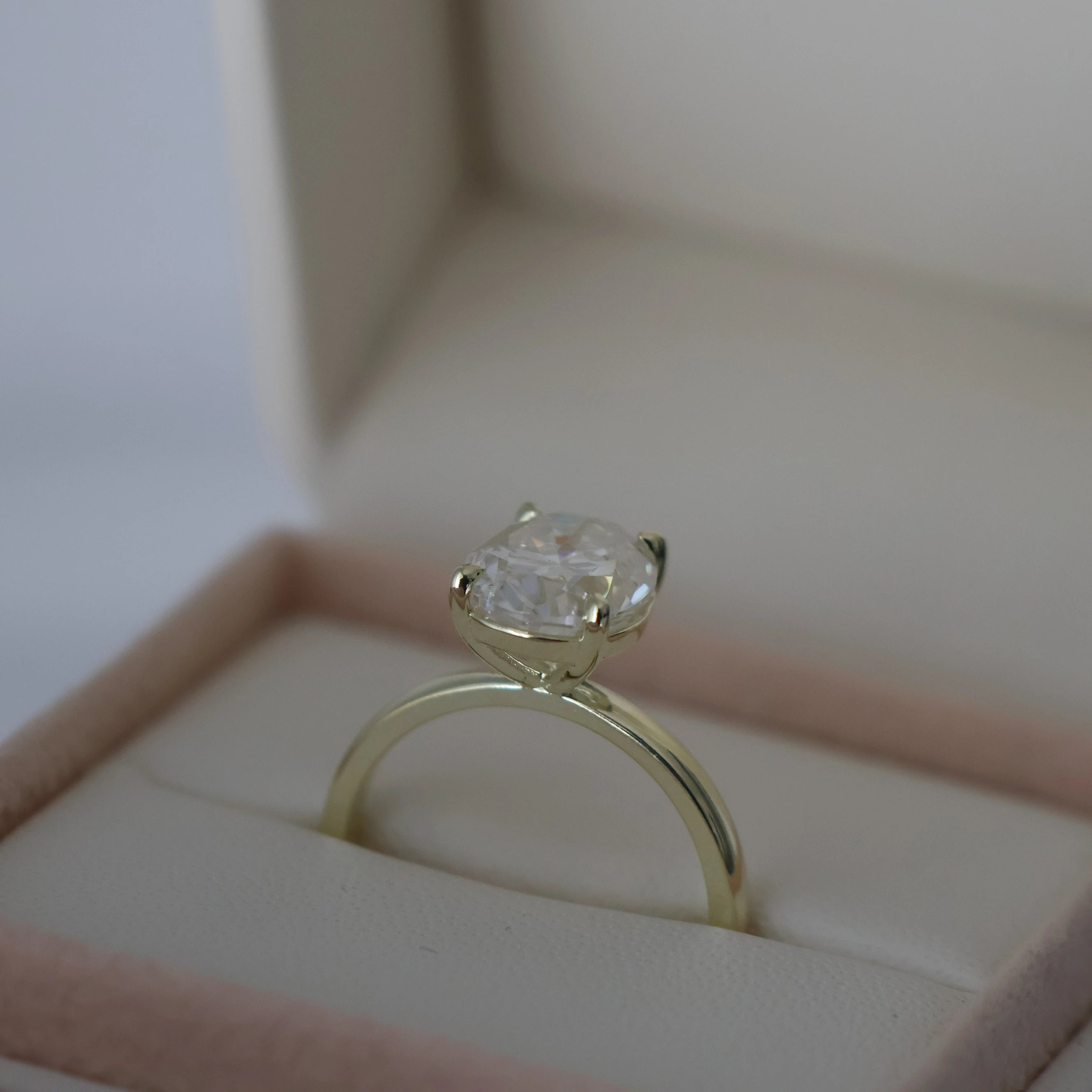 3 carat oval moissanite ring in light 14k gold filled in a proposal box