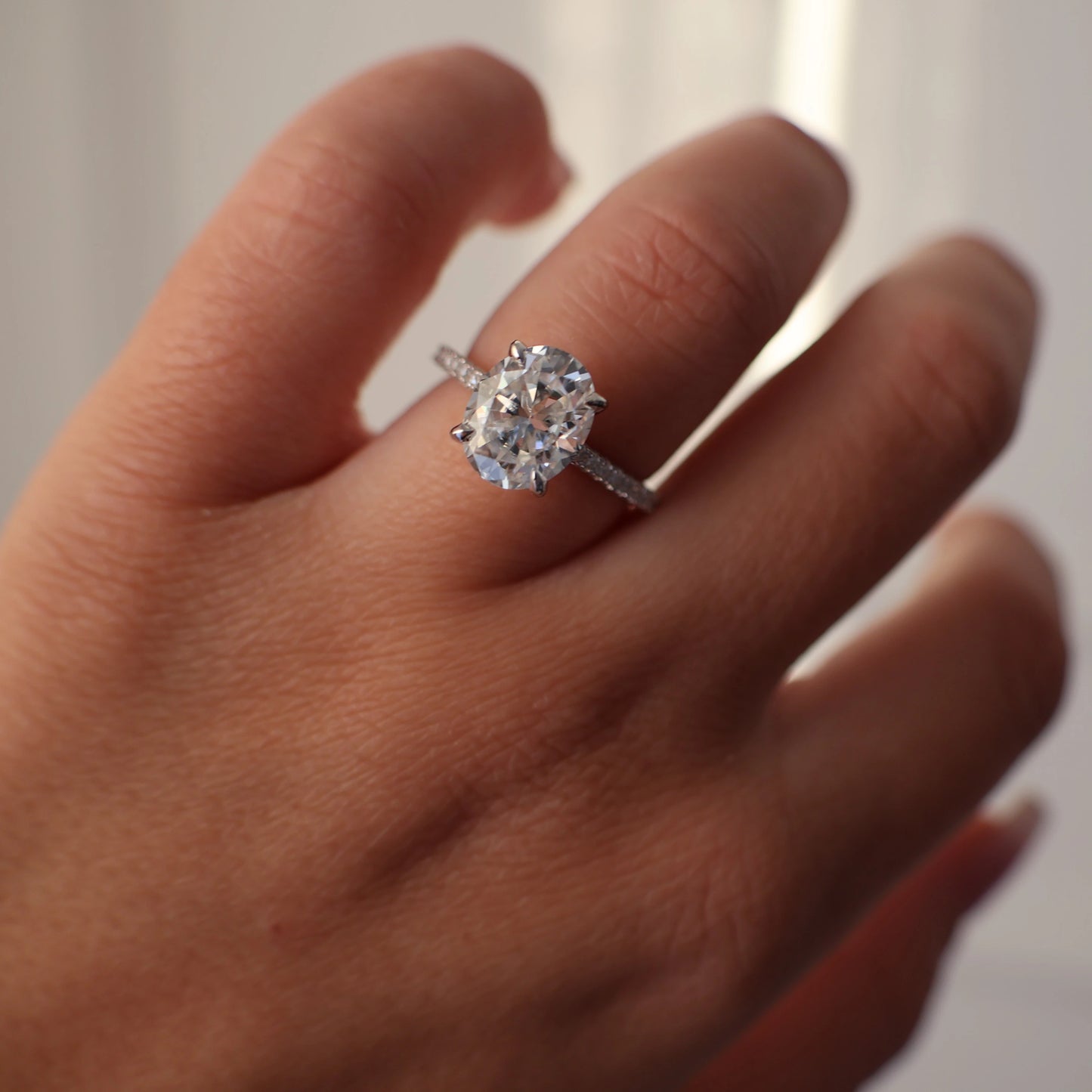 3 carat oval moissanite ring with pave band in silver