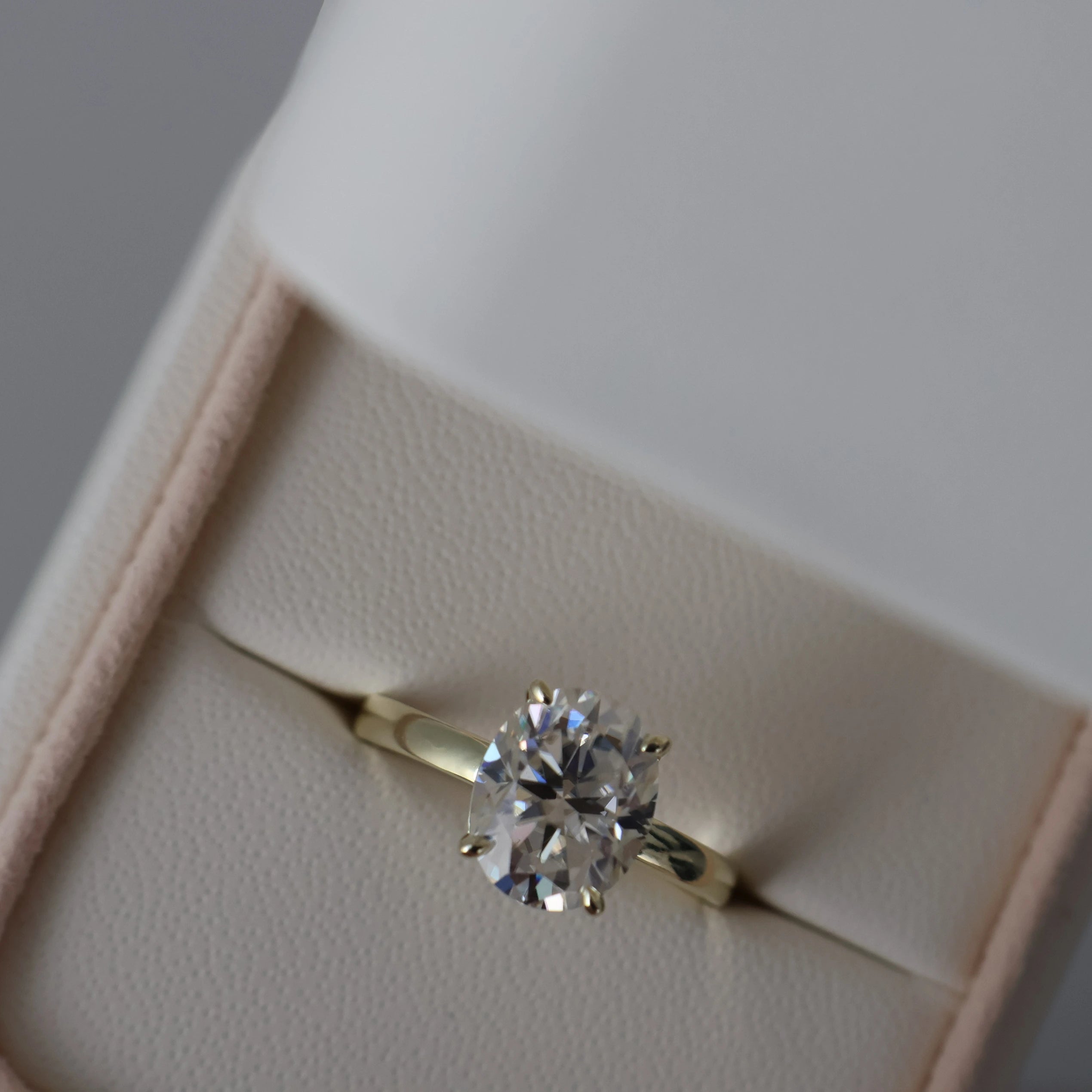 3 carat oval moissanite ring in soft yellow gold