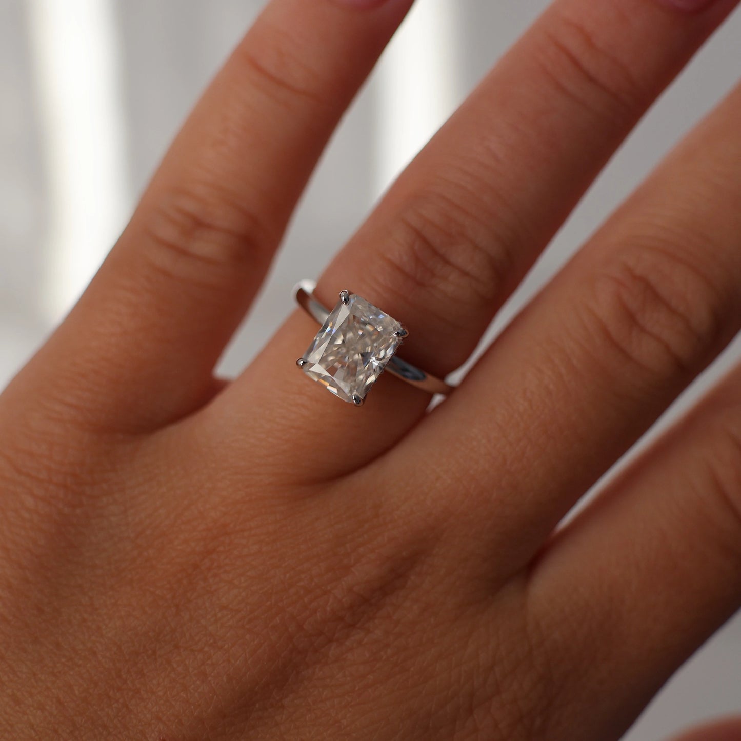 3 carat radiant cut moissanite engagement ring in silver with hidden halo