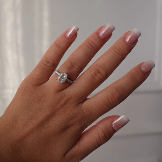3 carat silver elongated cushion moissanite ring with crushed ice center stone, pave band, and hidden halo