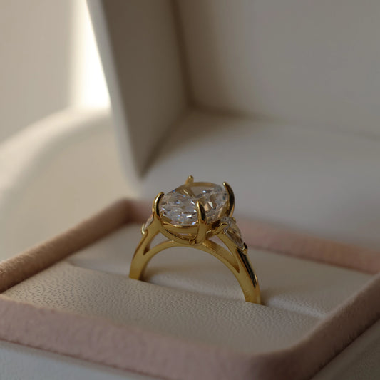 3.5 carat oval trilogy ring in 14K gold plated finish with pear cubic zirconia side stones