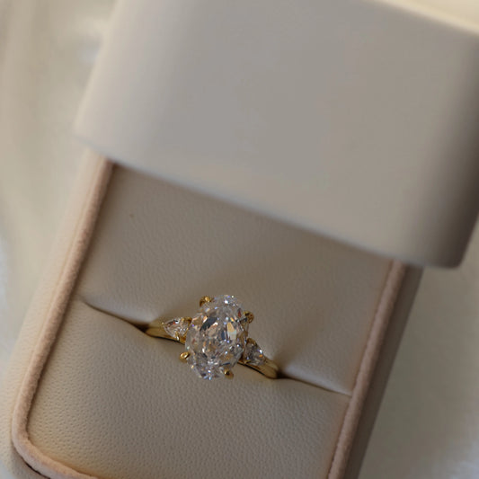 3.5 ct oval three stone 14K gold plated ring with pear side stones and cubic zirconia