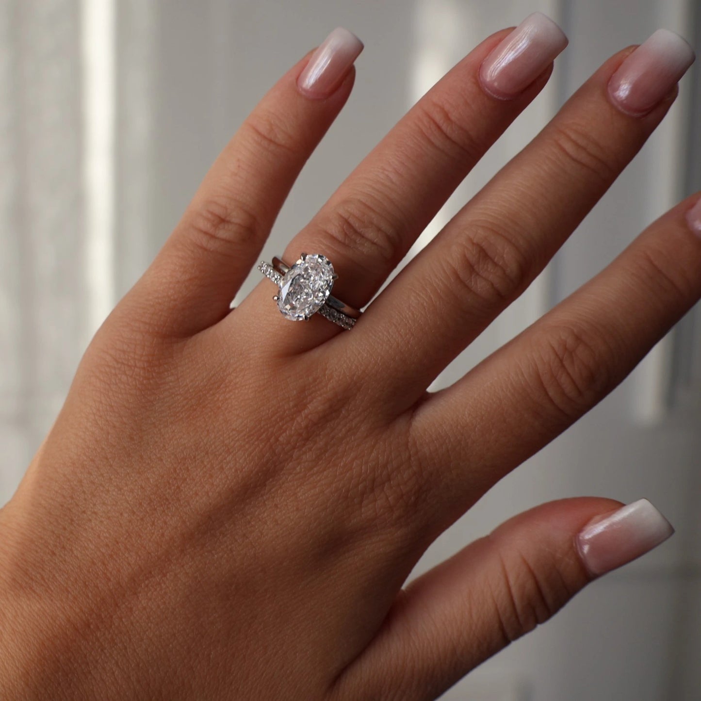 3.5 carat oval cut cubic zirconia silver ring with crushed ice stone stacked with pave eternity band