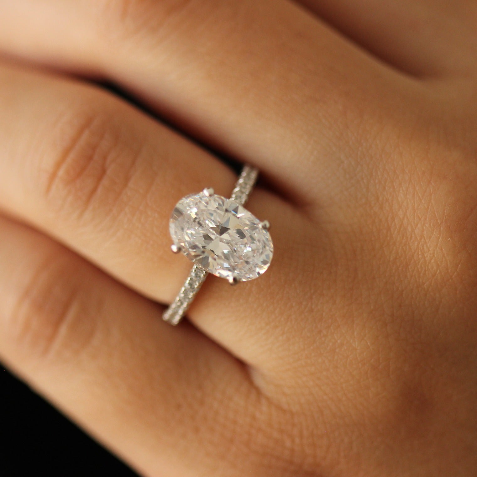 close up 3.5 carat silver cubic zirconia ring with pavé band design