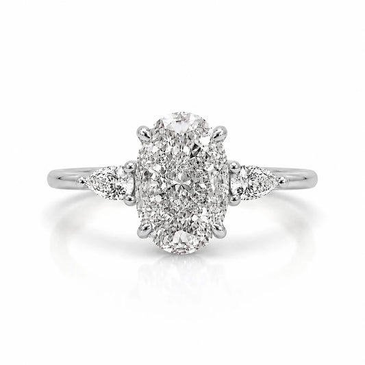3.5 carat three stone trilogy oval ring  with pear side stones in silver