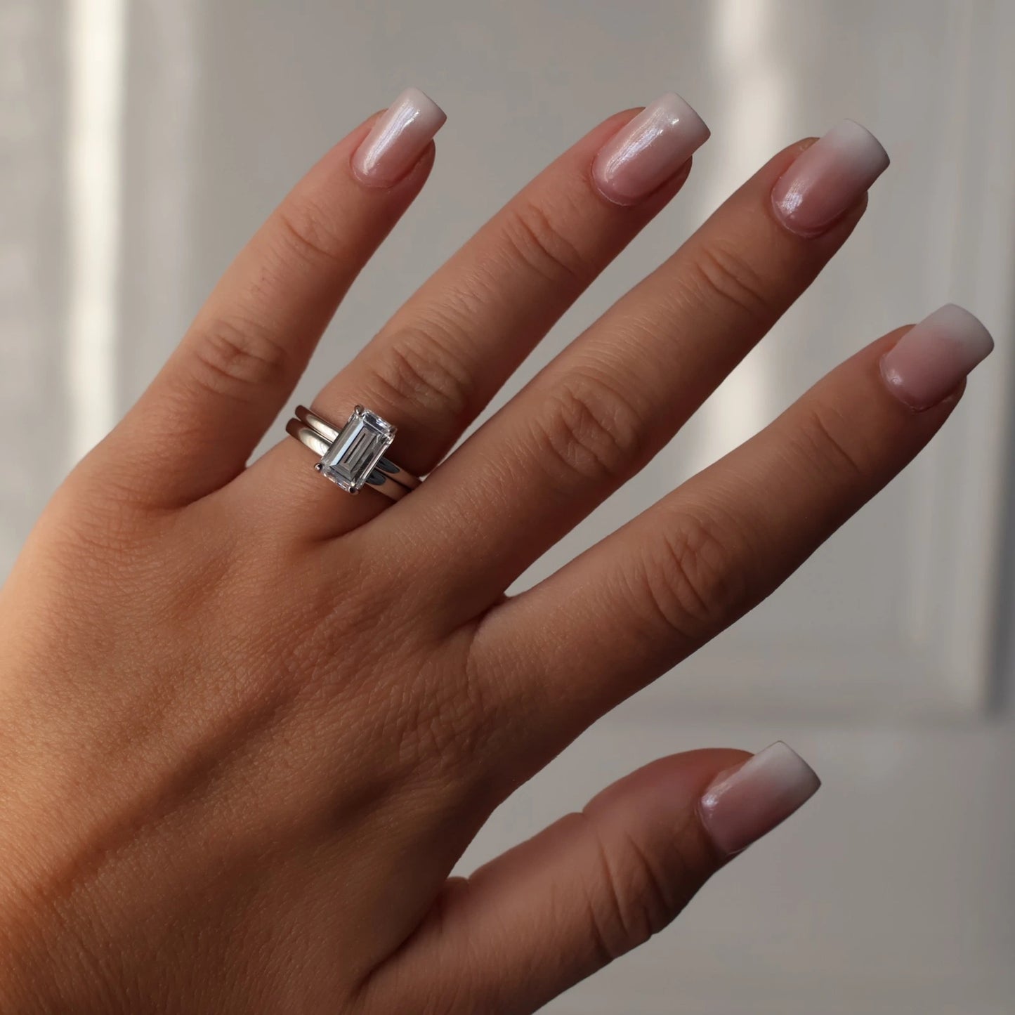 3 carat elongated emerald cut cubic zirconia silver ring stacked with silver wedding band