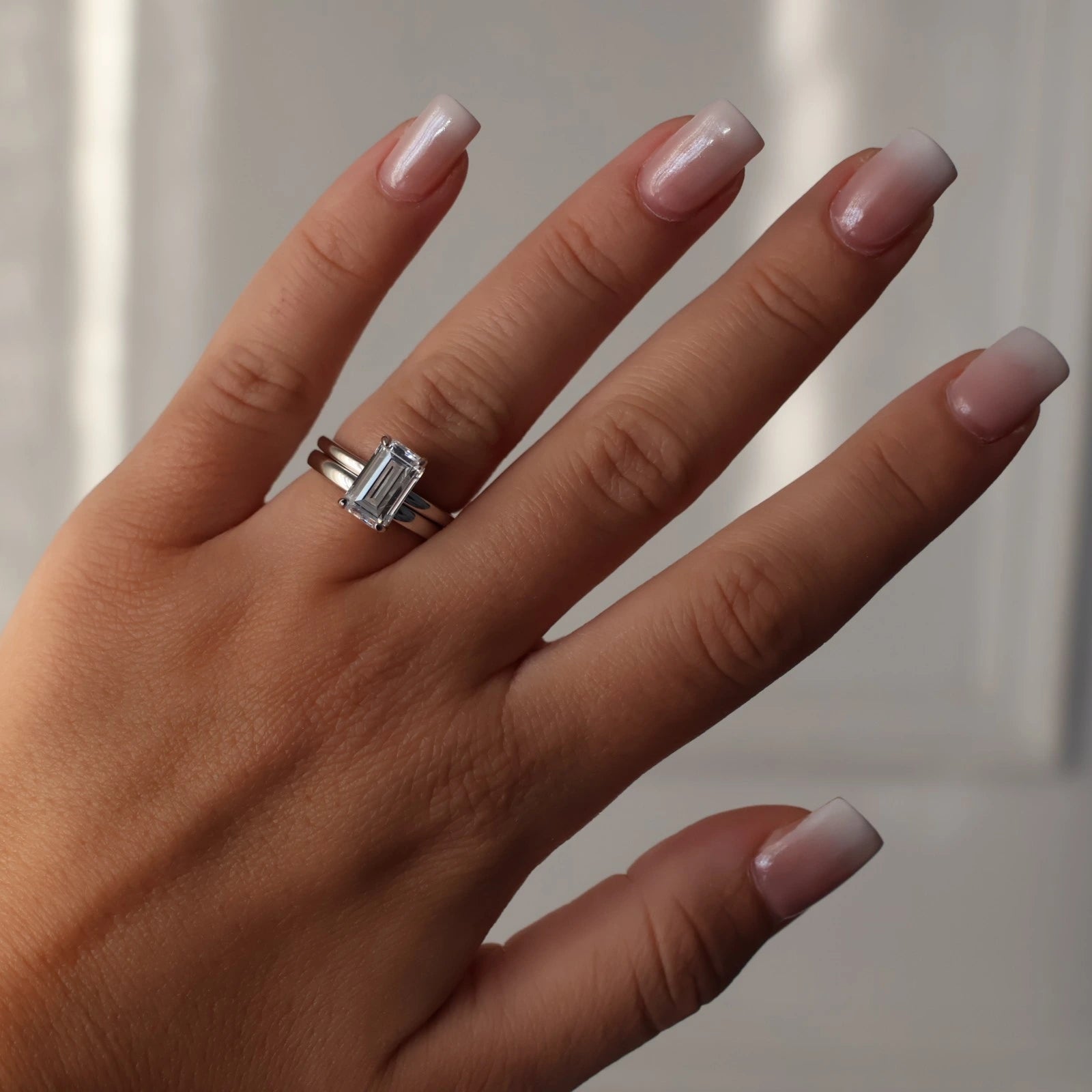3 carat elongated emerald cut cubic zirconia silver ring stacked with silver wedding band