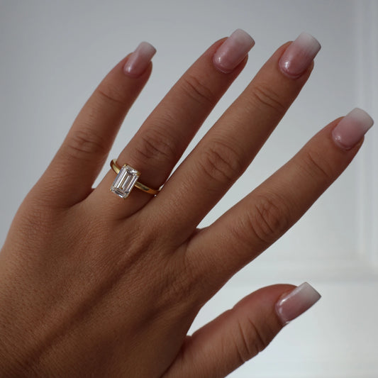 3 ct elongated emerald cut CZ ring in gold finish