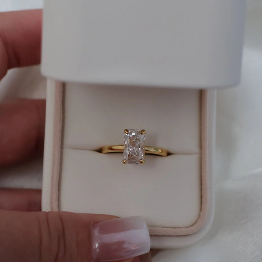 3 carat elongated radiant cut gold ring in engagement ring box