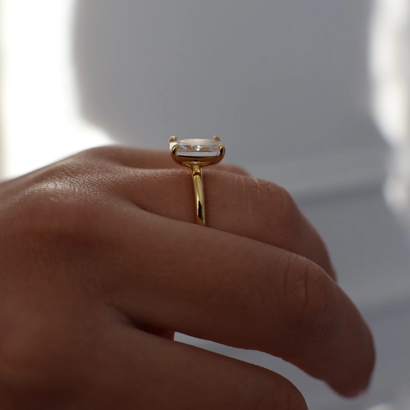 side profile of 3 carat elongated radiant cut ring in gold