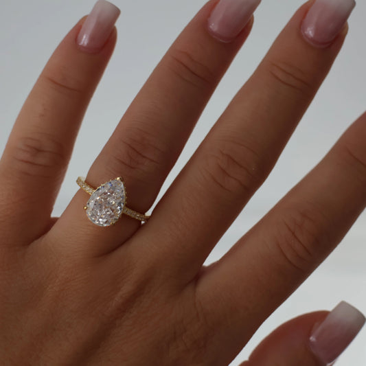 3 carat pear cut cubic zirconia ring in gold with pavé band
