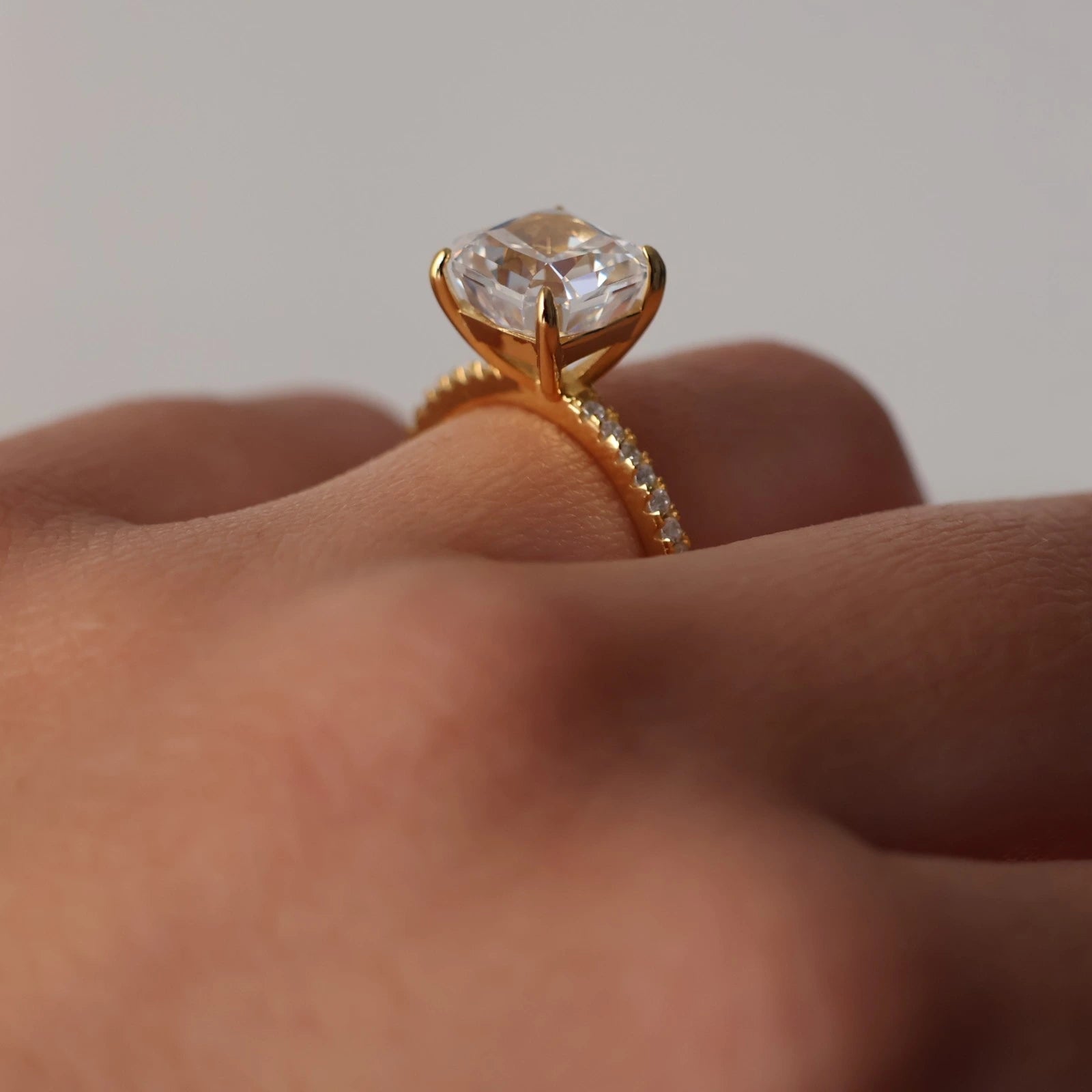 Side view of 3ct radiant square ring with pavé band