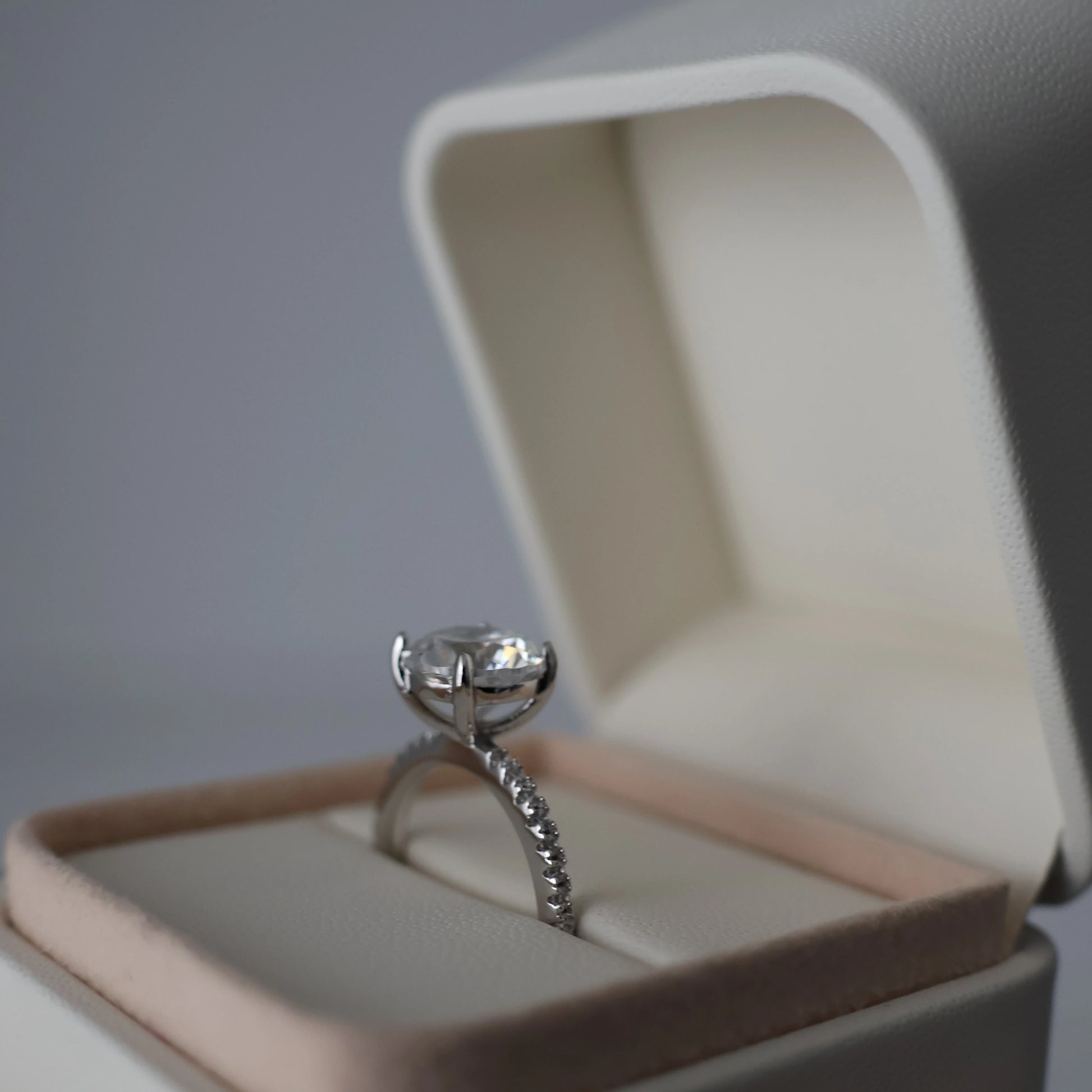 3ct round cut cubic zirconia pavé silver ring displayed in an open proposal box