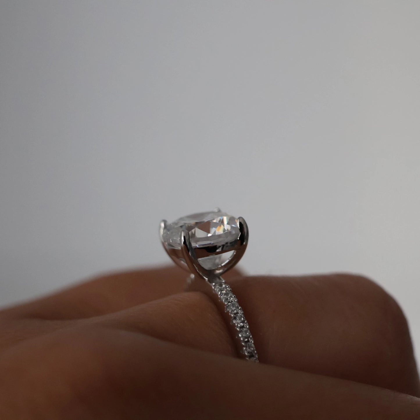 Side view of a 3ct round cut cubic zirconia ring with pavé silver band