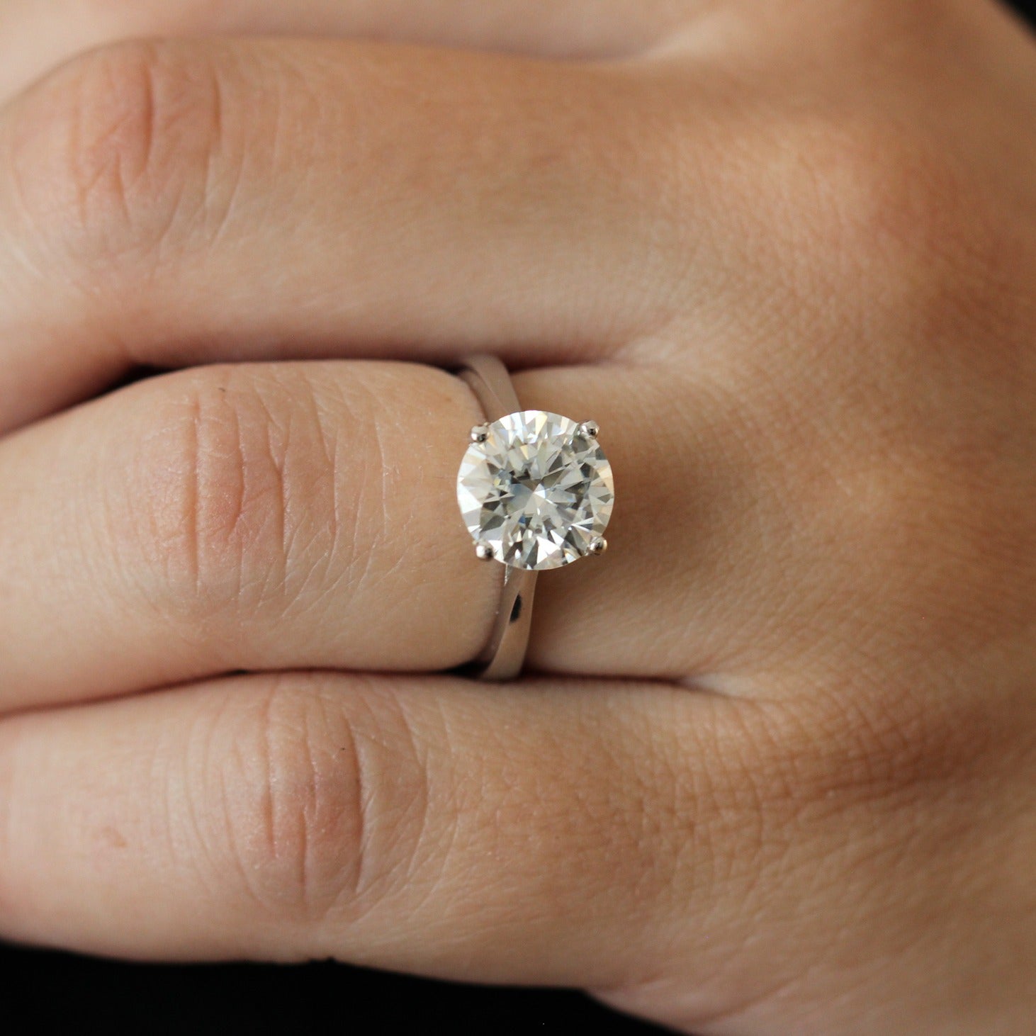 Close up of a 3 carat round moissanite solitaire ring