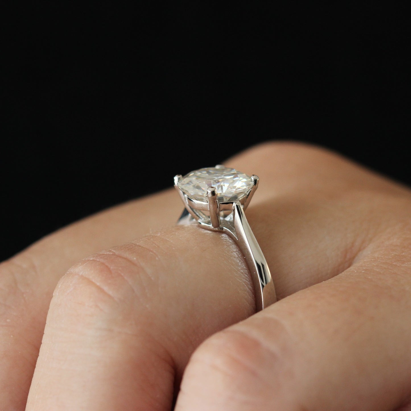 Side view of a 3 carat round moissanite solitaire ring