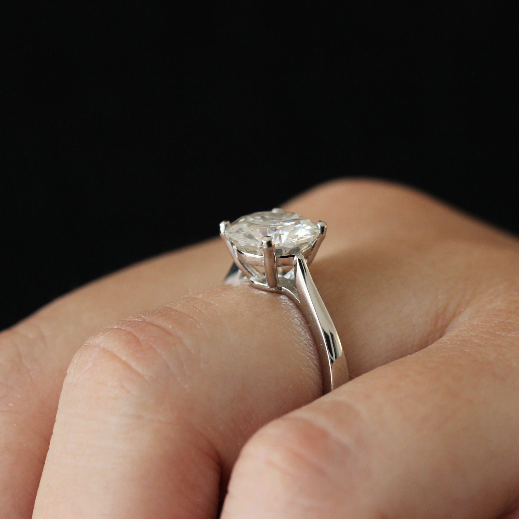 Side view of a 3 carat round moissanite solitaire ring
