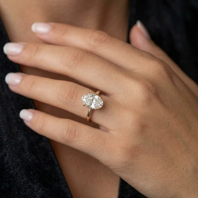 model wearing 4ct crushed ice oval moissanite engagement ring on ring finger