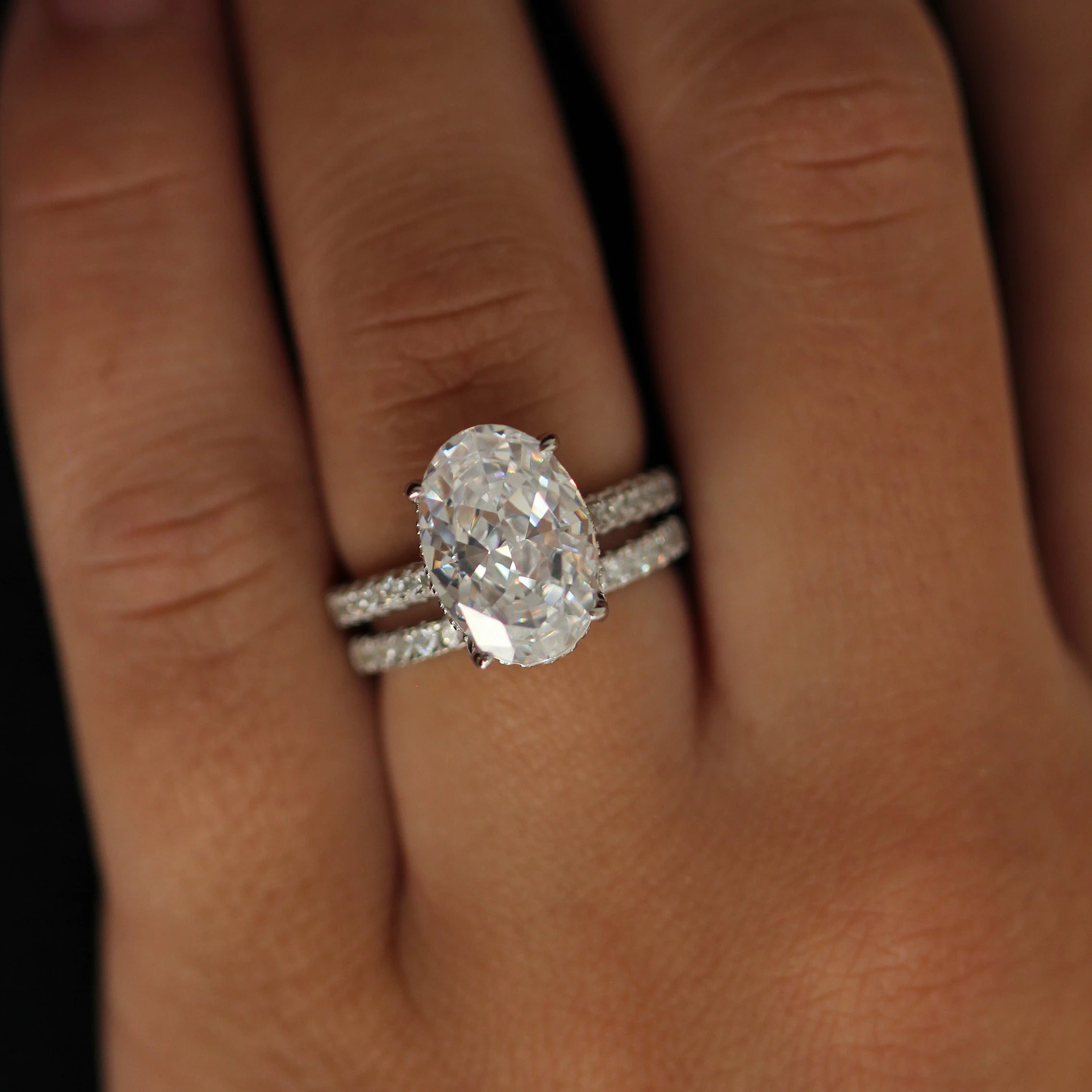 4 carat oval silver ring with hidden halo stacked with pavé band