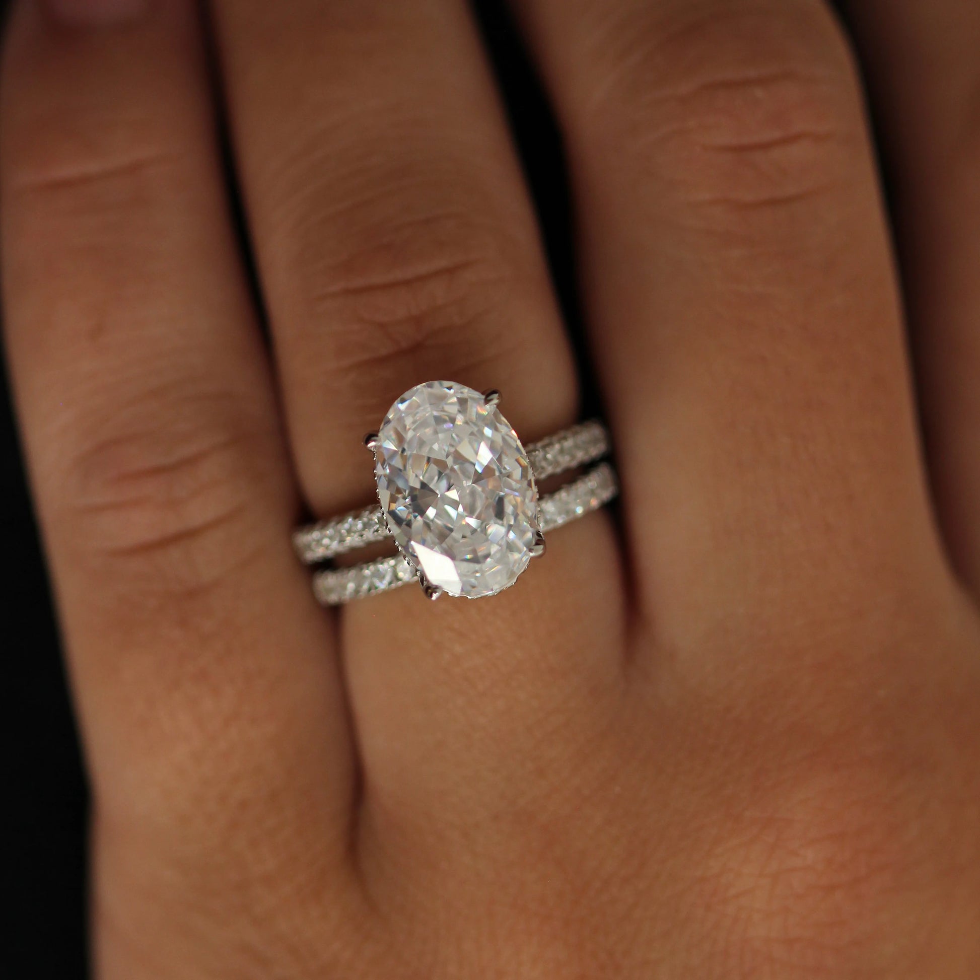 4 carat oval silver ring with hidden halo stacked with pavé band