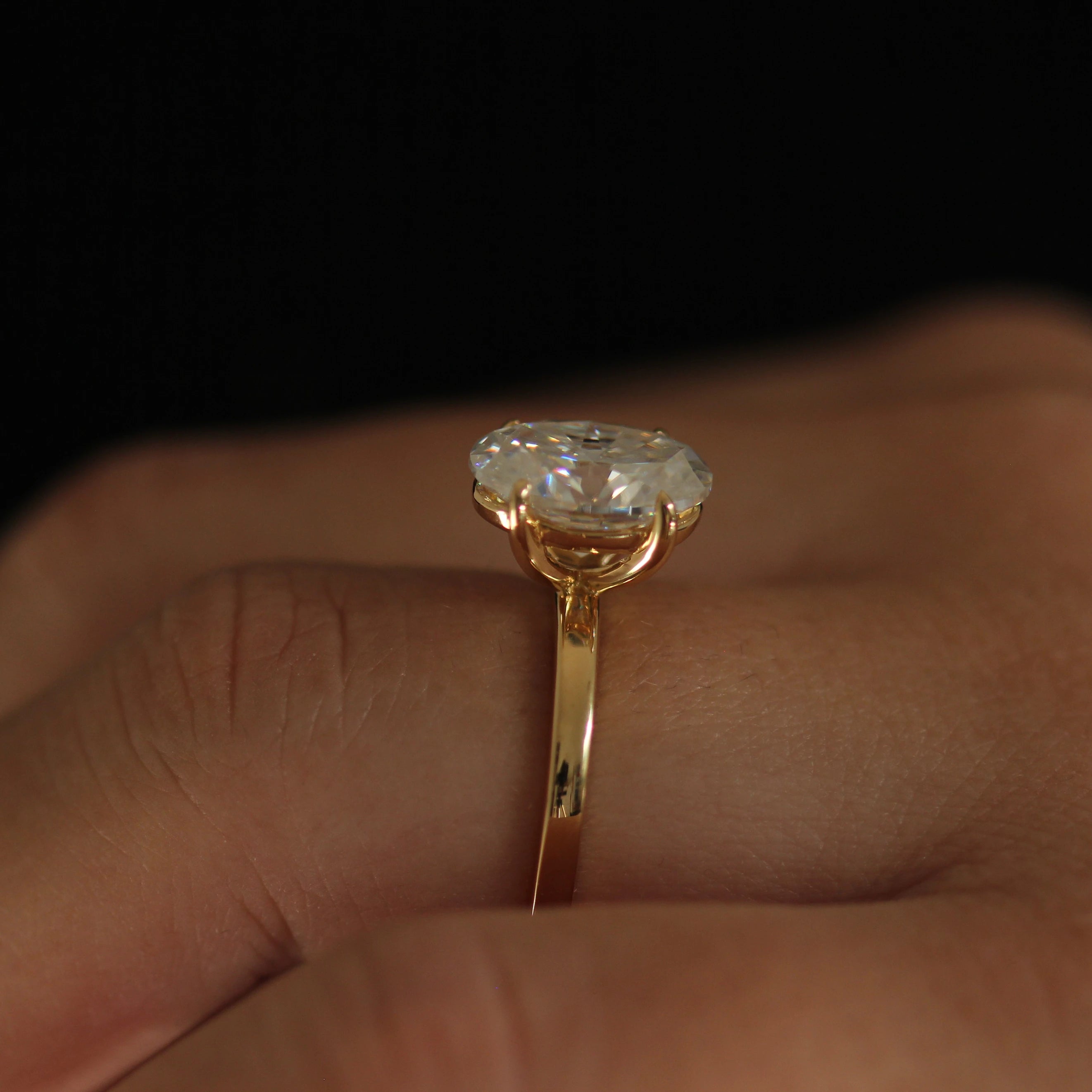 side angle showing 4 carat oval moissanite ring 14k gold filled band