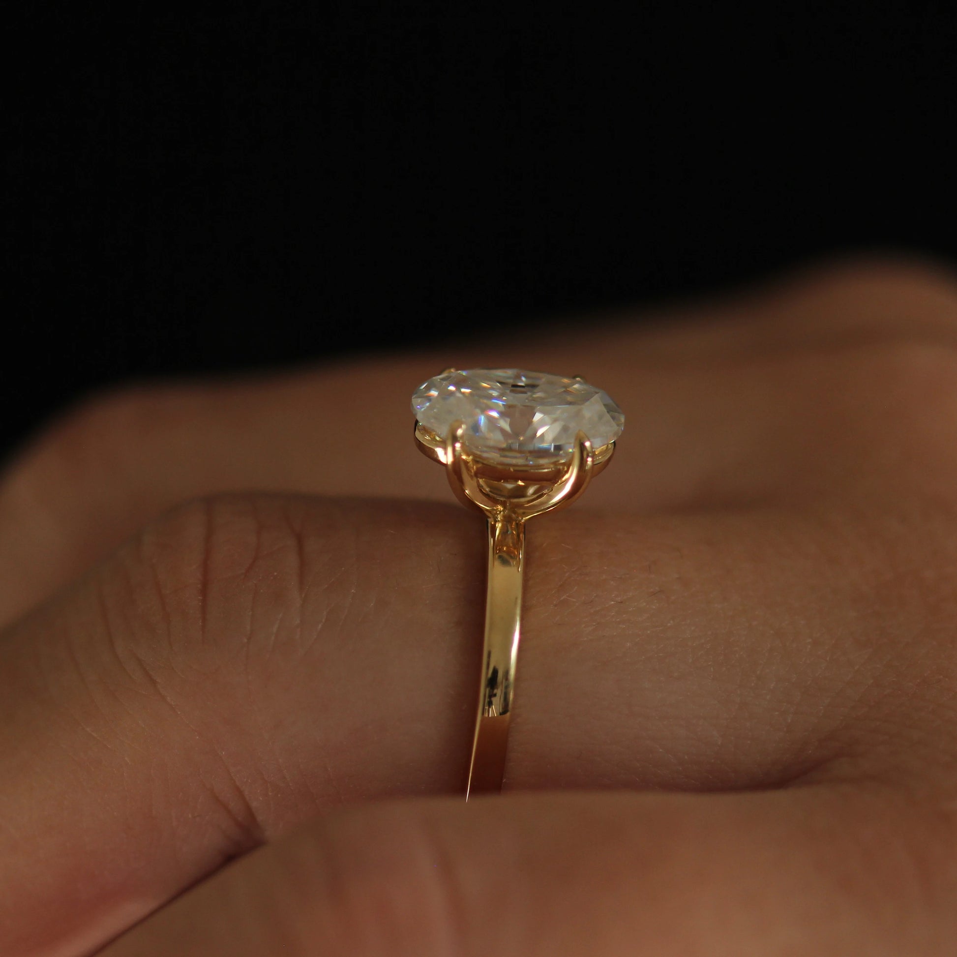side angle showing 4 carat oval moissanite ring 14k gold filled band