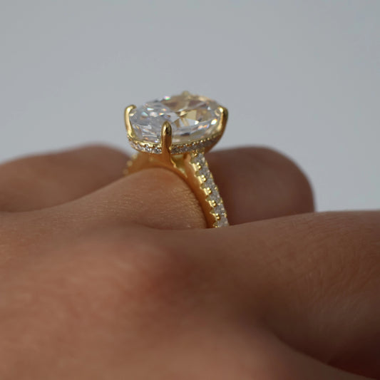 4 carat oval cut cubic zirconia ring in gold with pavé band and hidden halo