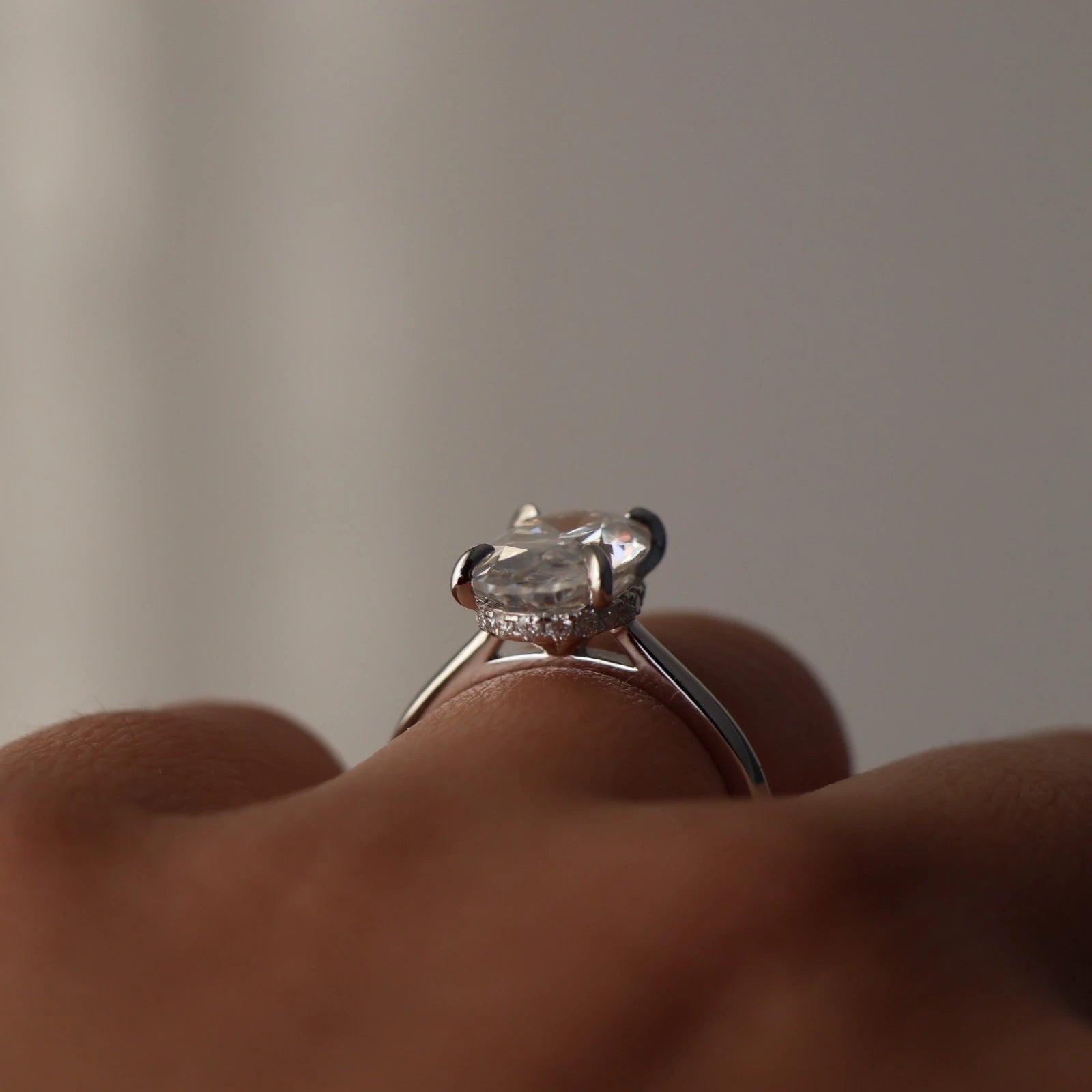Front view of 4 ct oval moissanite hidden halo ring in sterling silver