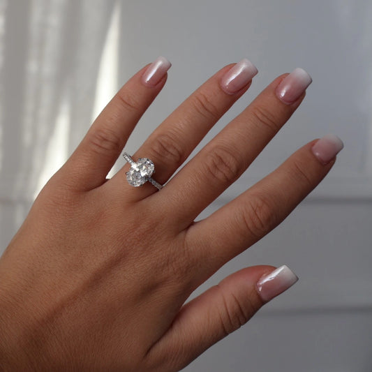 4 carat oval moissanite ring in silver with pavé band