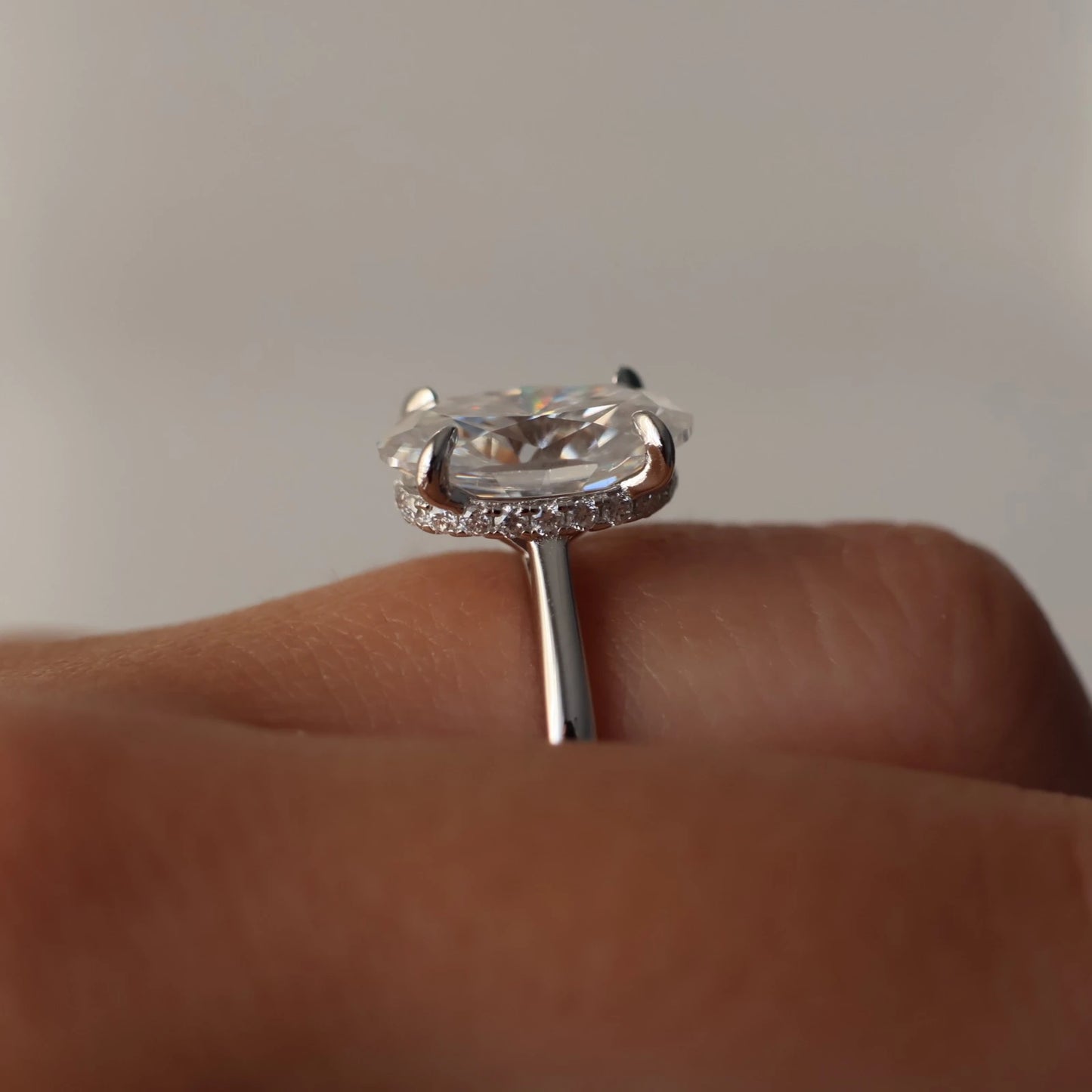 Side view of 4 ct oval moissanite ring with hidden halo in sterling silver
