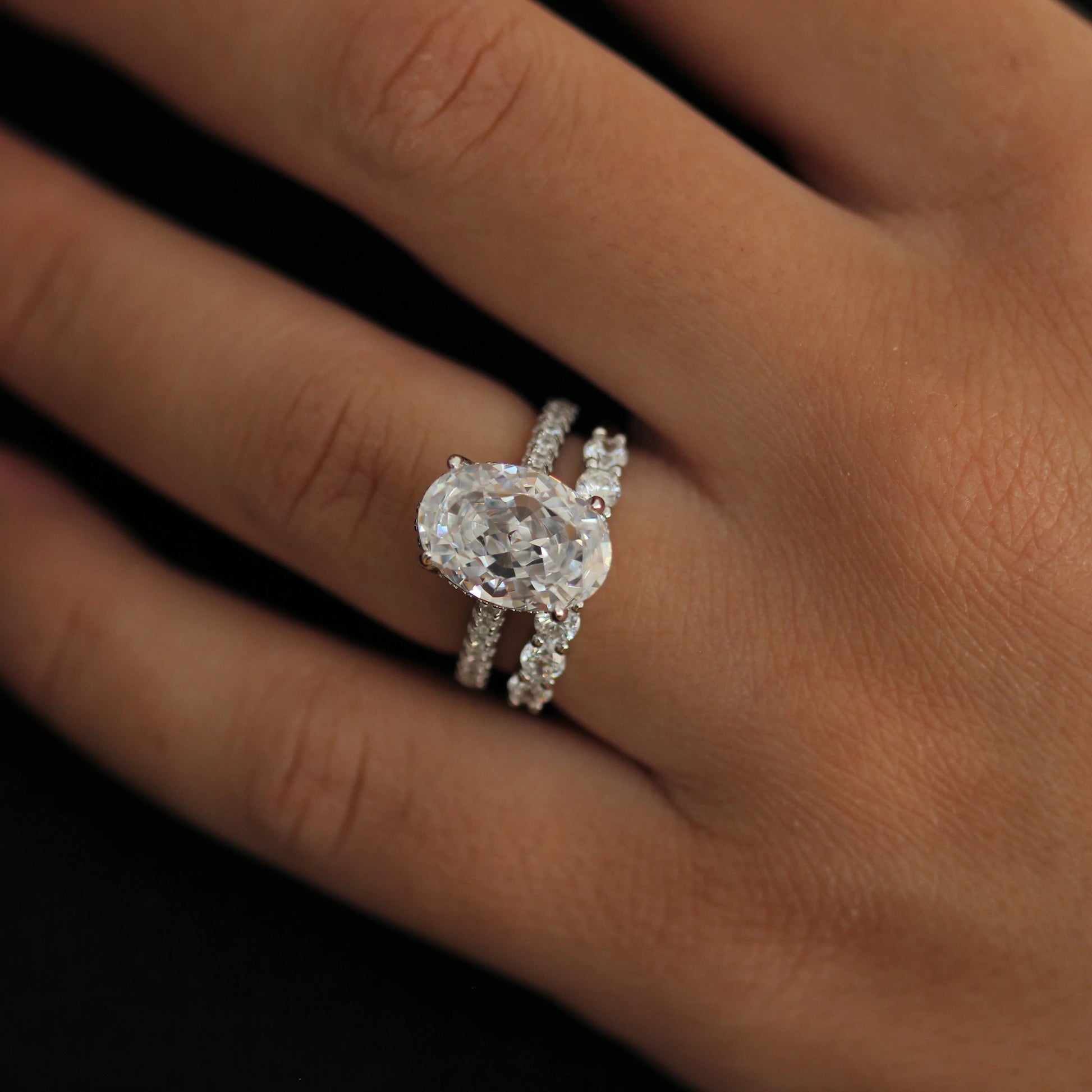 4 carat oval silver ring with hidden halo stacked with pavé band