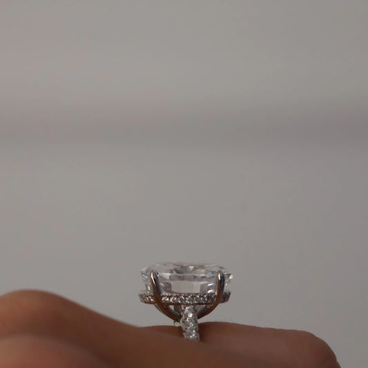 side profile of 4 carat oval silver ring with hidden halo and pavé band