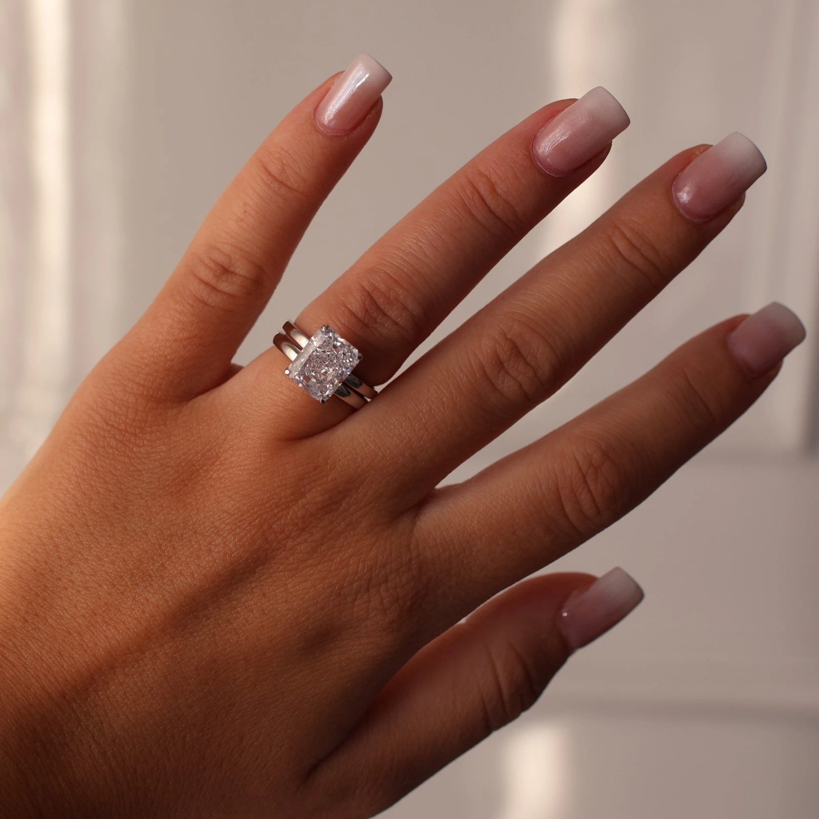 4 carat radiant cut silver solitaire ring stacked with silver band