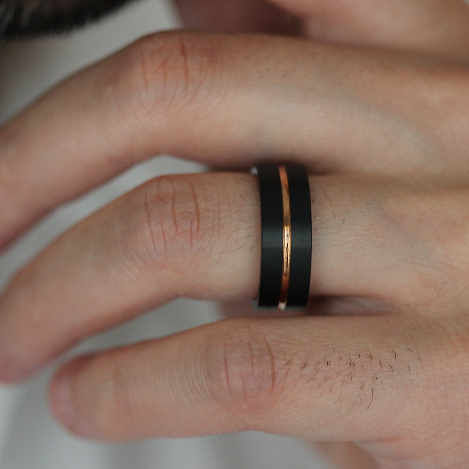 8mm black tungsten mens wedding band with rose gold centre groove 