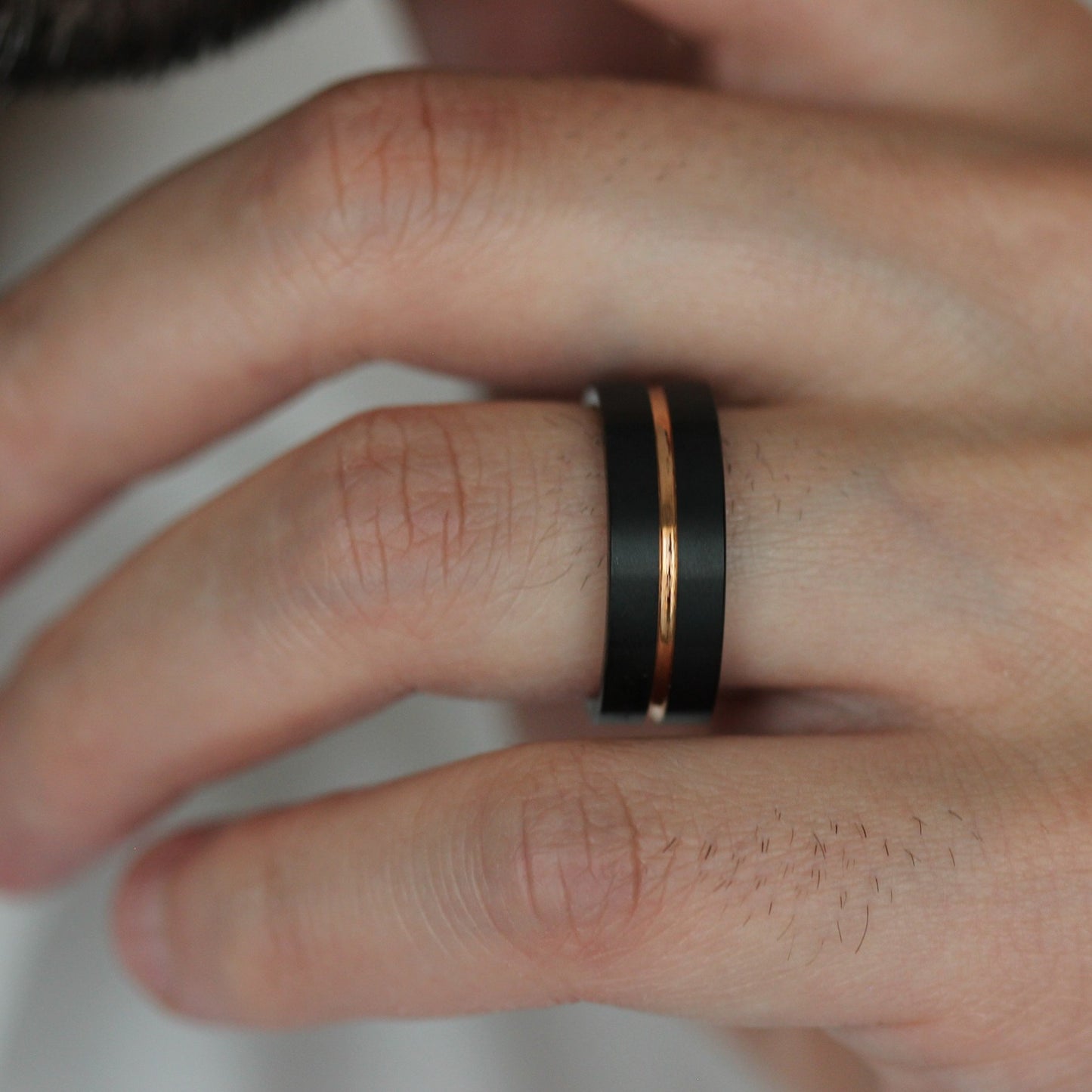 8mm black tungsten mens wedding band with rose gold centre groove 