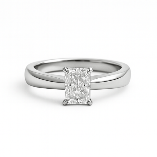 Radiant cut moissanite ring on plain band on white background