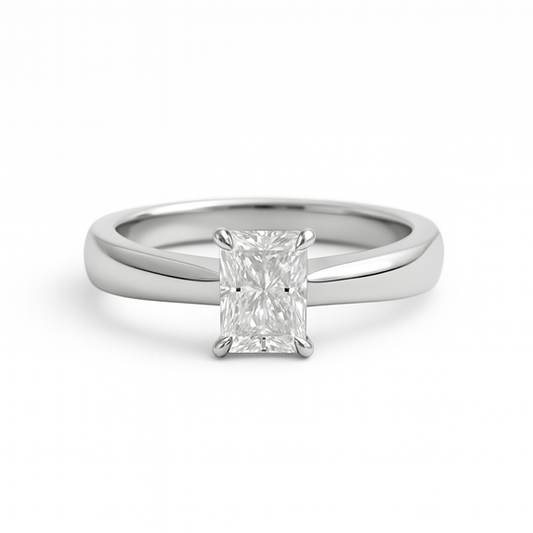 Radiant cut moissanite ring on plain band on white background