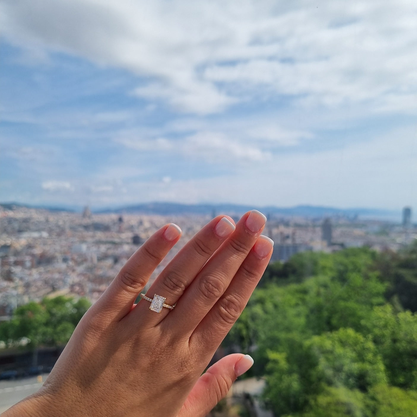 Gold radiant cut rectangle ring on hand in Barcelona
