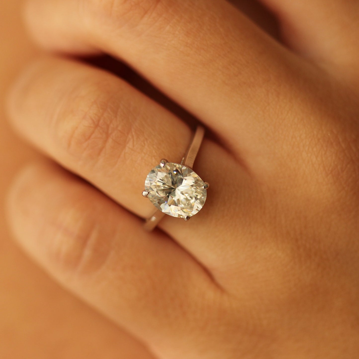 Silver cubic zirconia oval ring on hand