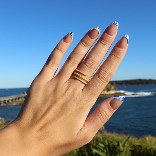 Gold spiral ring on hand at La Perouse Beach Sydney