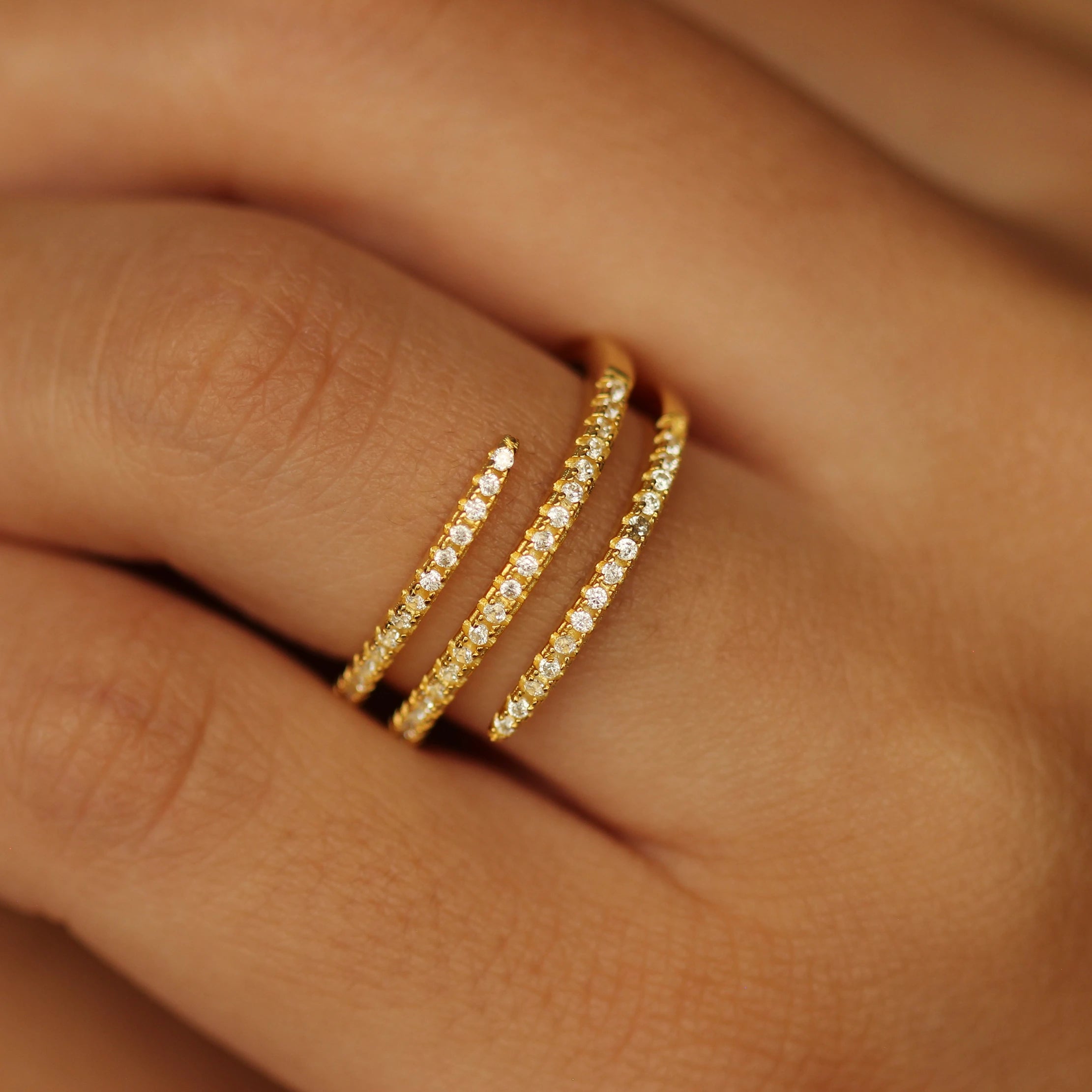 Gold spiral ring on hand