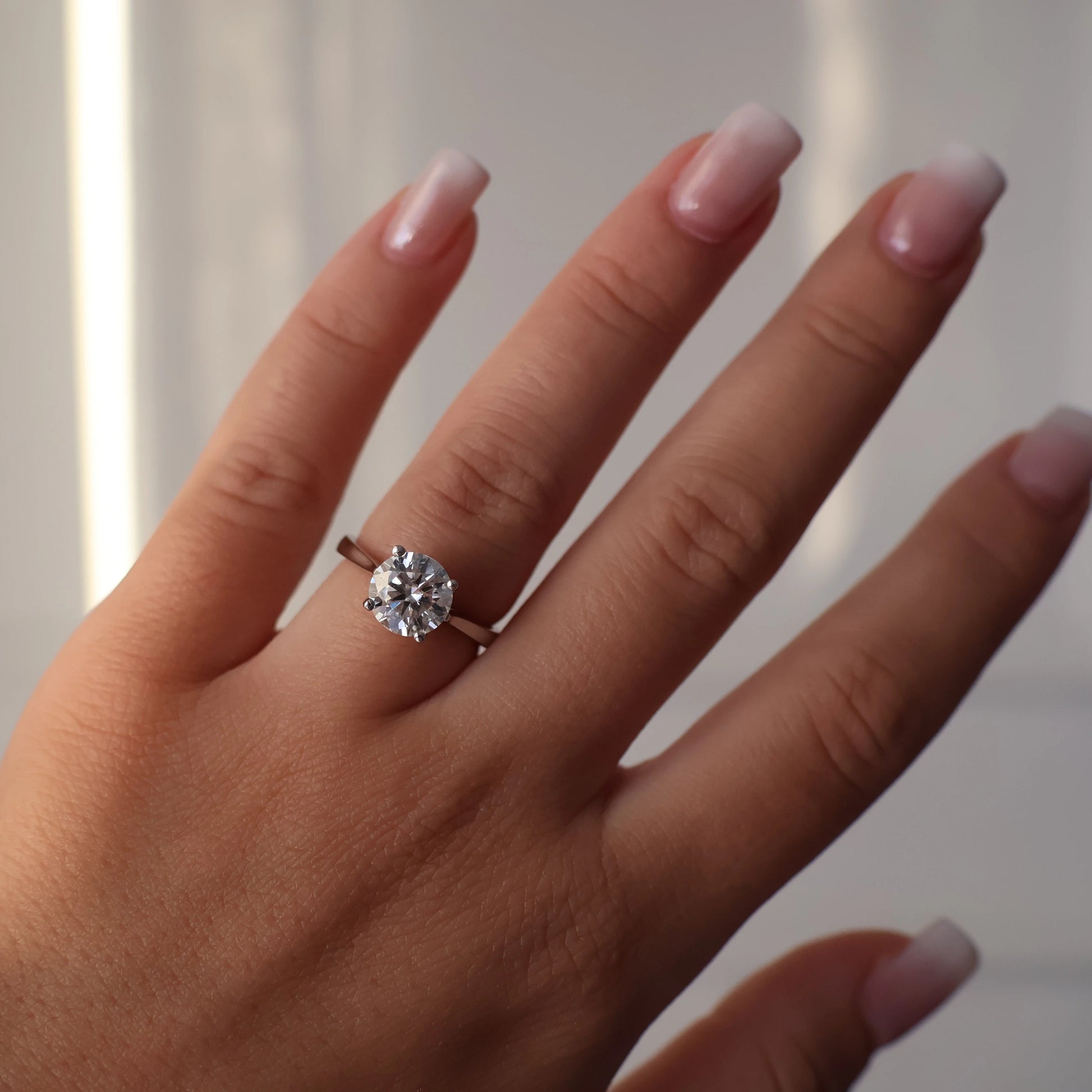 2ct round moissanite ring on hand