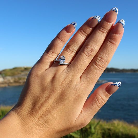 Oval cubic zirconia ring on hand at La Perouse Beach, Sydney