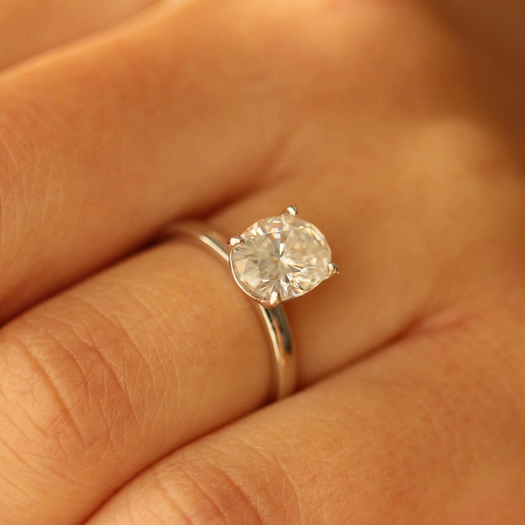 2ct oval moissanite ring on hand