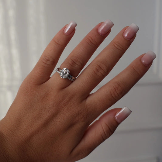 2ct oval moissanite ring on hand stacked with half eternity band